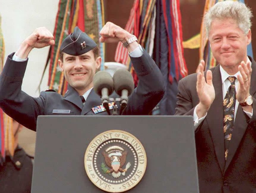 Scott O’Grady is welcomed back to the US by Bill Clinton after his F-16 was shot down over Bosnia. O’Grady avoided capture for six days before US marines rescued him (AFP via Getty Images)