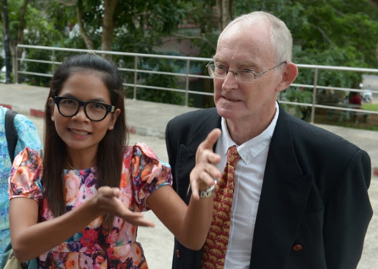 Australian journalist Alan Morison (R) and Thai colleague Chutima Sidasathian arrive at the provincial court on Phuket island, on September 1, 2015