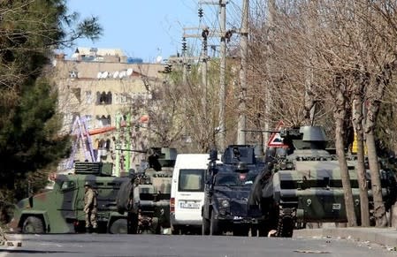 Military and police armored vehicles are parked in Baglar district, which is partially under curfew, in the Kurdish-dominated southeastern city of Diyarbakir, Turkey March 17, 2016. REUTERS/Sertac Kayar