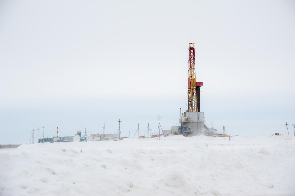 a drilling rig in a snowy field.