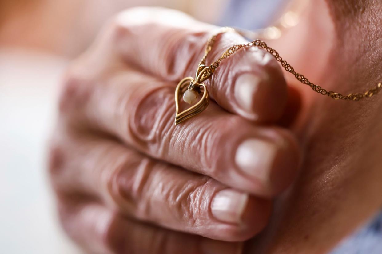 Vicky Cupp holds up the necklace her late daughter Kyle Smith gave her as a Christmas gift before her death. Cupp says she always wears the necklace to remember her daughter who was shot and killed outside of a club on Woodward avenue the night before Super Bowl XL in Detroit.