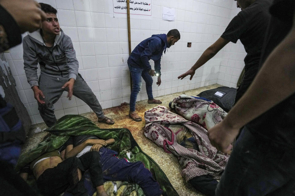 Bodies of people killed in the Israeli bombardment of the Gaza Strip are brought to al Aqsa Hospital in Deir al Balah, Gaza Strip, Tuesday, April 9, 2024. (AP Photo/Abdel Kareem Hana)