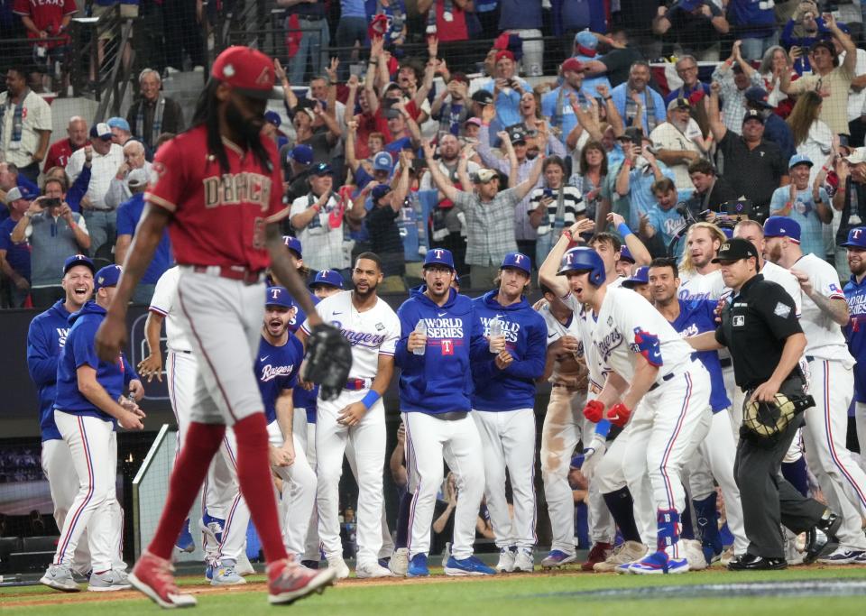 Arizona Diamondbacks pitcher Miguel Castro (50) walks off the field as the Texas Rangers celebrate Adolis GarcÃ­a's walk-off home run in the 11th inning to win Game 1 of the World Series 6-5 at Globe Life Field in Arlington, Texas, on Oct. 27, 2023.