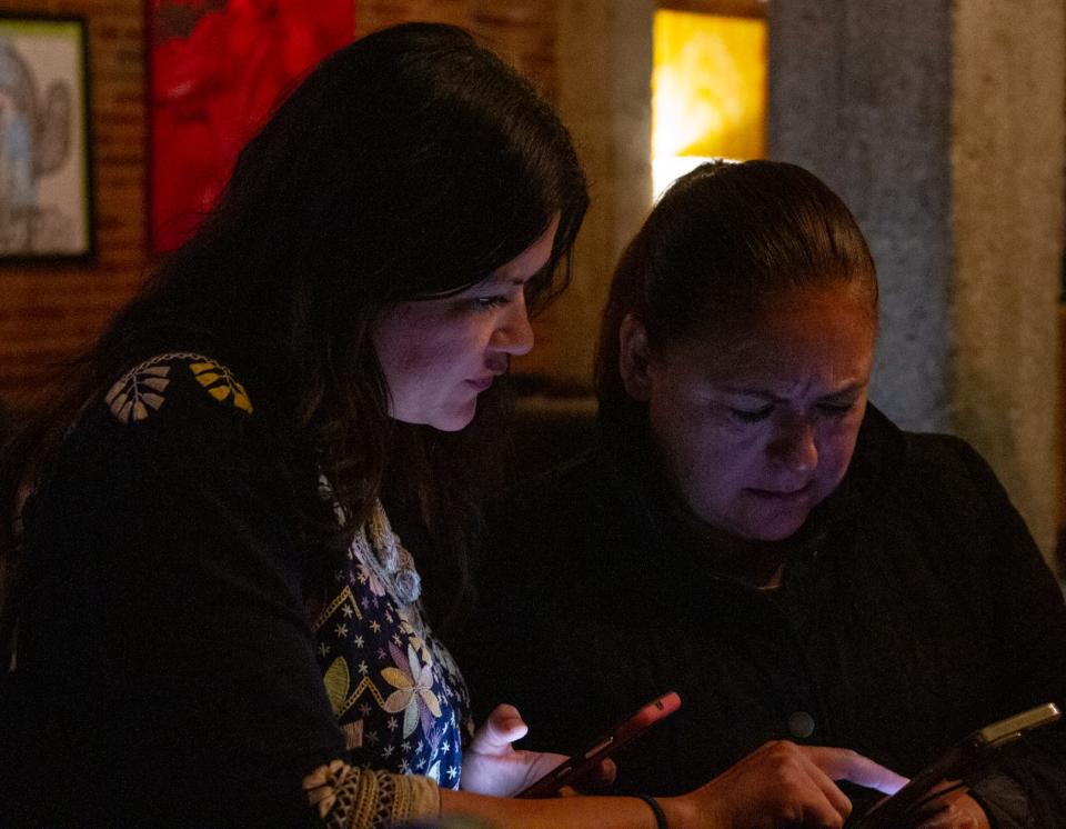 Veronica Carbajal looks at early voting results with supporters at Old Sheepdog Brewery on Dec. 9, 2023.