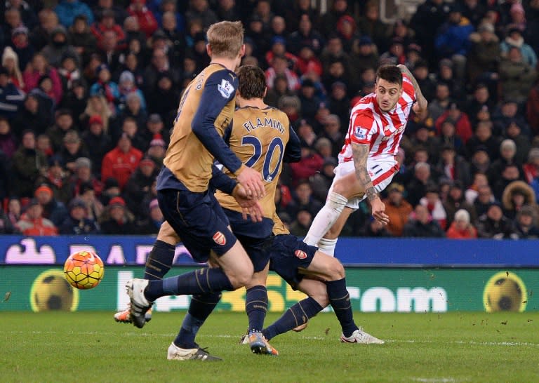 Stoke City's Mato Joselu (R) attempts an unsuccessful shot on goal during an English Premier League match against Stoke City in England on January 17, 2016