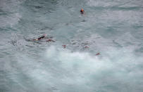 <p>In this photo provided by America’s Cup Event Authority, Emirates Team New Zealand debris and a crewman float after capsizing during an America’s Cup challenger semifinal against Great Britain’s Land Rover BAR on the Great Sound in Bermuda on Tuesday, June 6, 2017. (Gilles Martin-Raget/ACEA via AP) </p>