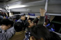 Commuters ride a bus into Beijing, China, November 16, 2015. REUTERS/Kim Kyung-Hoon