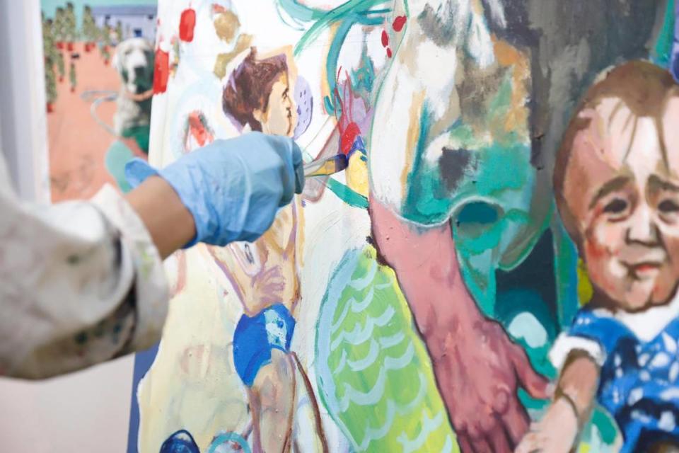 Charlotte artist Samantha Rosado works on a painting in her new studio at the McColl Center. Thirty Charlotte area artists applied for the McColl’s new studio rental program. Rosado was one of eight chosen to occupy the renovated studio spaces for the first year.