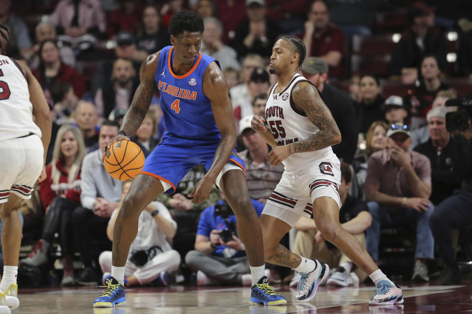 Florida forward Tyrese Samuel (4) makes a move to the basket against South Carolina guard Ta'Lon Cooper (55) during the first half of an NCAA college basketball game Saturday, March 2, 2024, in Columbia, S.C. (AP Photo/Artie Walker Jr.)