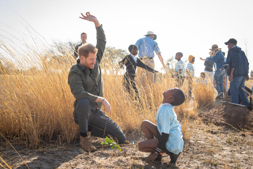 The Duke of Sussex during a tree planting event with local children, at the Chobe National Park, Botswana.