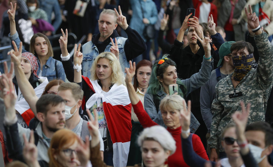 People gesture during a protest at the Independence Square in Minsk, Belarus, Thursday, Aug. 27, 2020. Police in Belarus have dispersed protesters who gathered on the capital's central square, detaining dozens. (AP Photo/Sergei Grits)