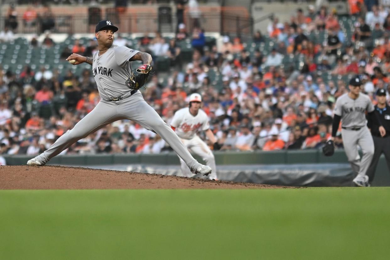 May 1, 2024; Baltimore, Maryland, USA; New York Yankees pitcher Luis Gil (81) throws a third inning pitch as Baltimore Orioles outfielder Heston Kjerstad (13) takes a lead at Oriole Park at Camden Yards. Mandatory Credit: Tommy Gilligan-USA TODAY Sports