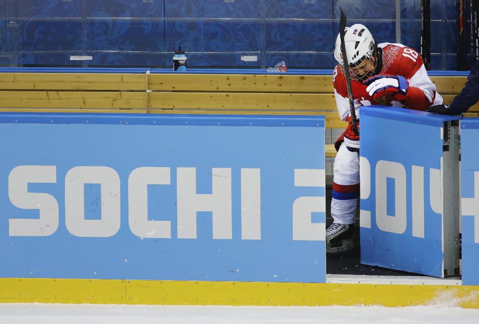 Olga Sosina of Russia sits on the bench after Russia's 2-0 loss to Swtizerland during the 2014 Winter Olympics women's ice hockey quarterfinal game at Shayba Arena, Saturday, Feb. 15, 2014, in Sochi, Russia. (AP Photo/Matt Slocum)