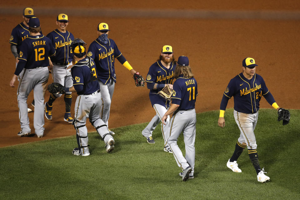 The Milwaukee Brewers celebrates after beating the Chicago Cubs 4-3 in a baseball game Friday, Aug. 14, 2020, in Chicago. (AP Photo/Jeff Haynes)