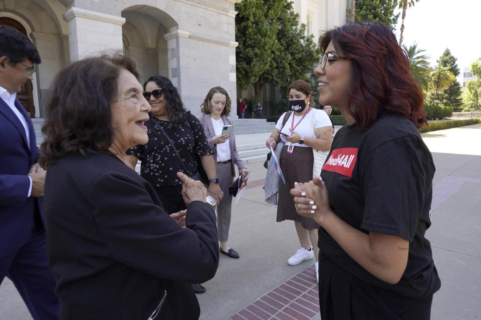 Civil rights activist Dolores Huerta, left, talks with Beatriz Hernandez, right, at a rally calling for health care for all low-income immigrants living in the country illegally, held at the Capitol in Sacramento, Calif., on Wednesday, June 29, 2022. Hernandez' health care insurance has fluctuated because of her immigration status. Gov. Gavin Newsom is expected to sign a $307.9 billion operating budget on Thursday June 30, 2022, that makes all low-income adults eligible for the state's Medicaid program regardless of their immigration status.(AP Photo/Rich Pedroncelli)