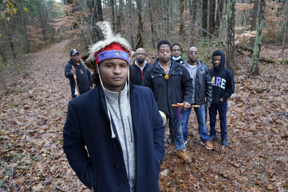 Larry Fisher, chief sachem of the Mattakeeset Massachuset tribe, foreground, poses with other tribal members at Titicut Indian Reservation, Friday, Nov. 27, 2020, in Bridgewater, Mass. A rift has been widening between Native American groups in New England over a federal reservation south of Boston where one tribe is planning to build a $1 billion casino. The Mattakeeset Massachuset tribe contend the Mashpee Wampanoag tribe doesn't have exclusive claim to the lands under their planned First Light casino in the city of Taunton, as they've argued for years. (AP Photo/Elise Amendola)