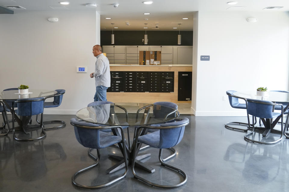 Jefferson Union High School District board trustee Andrew Lie walks through the mail room of the district's new housing complex in Daly City, Calif., Friday, July 8, 2022. The school district in San Mateo County is among just a handful of places in the country with educator housing. But with a national teacher shortage and rapidly rising rents, the working class district could serve as a harbinger as schools across the U.S. seek to attract and retain educators. (AP Photo/Godofredo A. Vásquez)