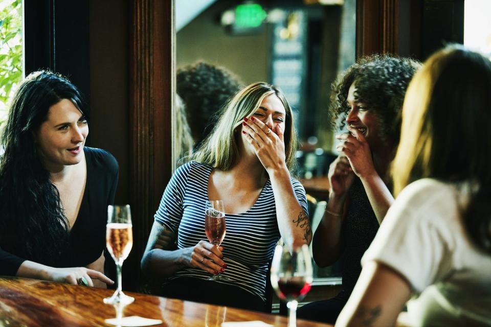friends laughing at a pub