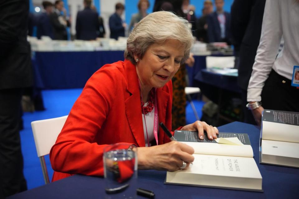 Theresa May signing copies of The Abuse of Power at Conservative Party Conference (Getty Images)