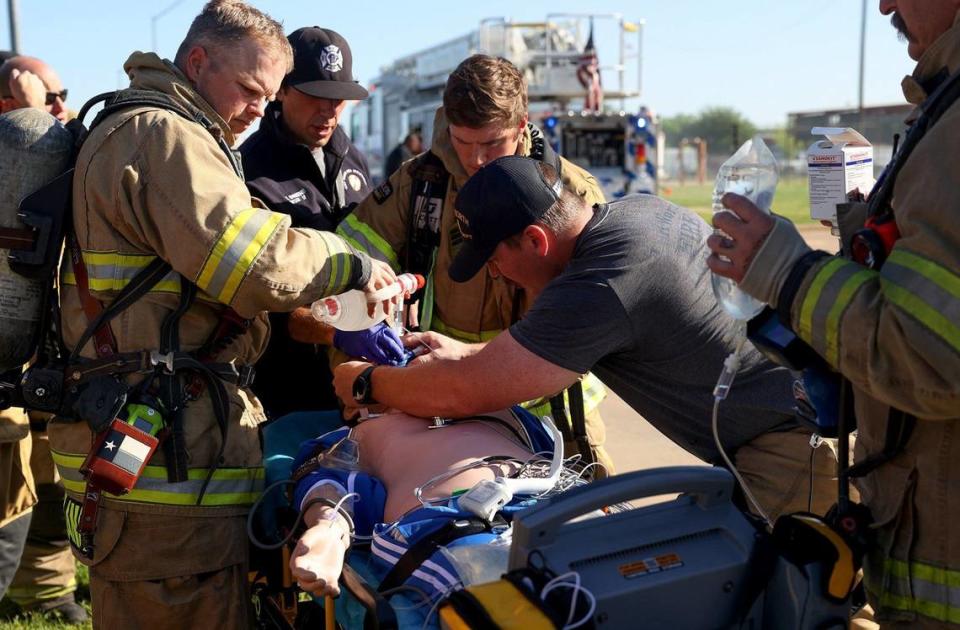 Fort Worth Fire Department members simulate a fire rescue during a training exercise on Friday. City officials were invited to participate in a training session to learn what firefighters face on a day-to-day basis.