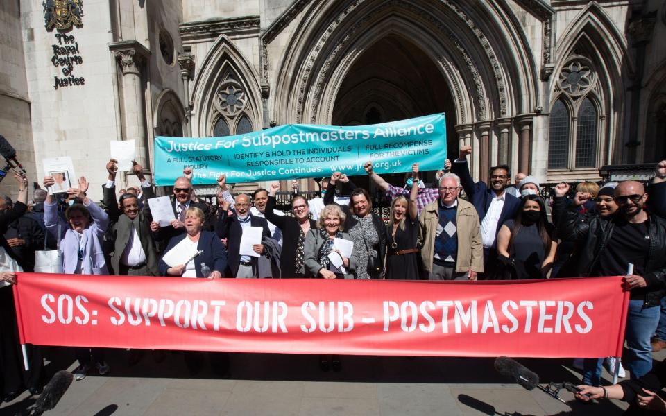 Postmasters celebrate outside the High Court after their convictions were quashed