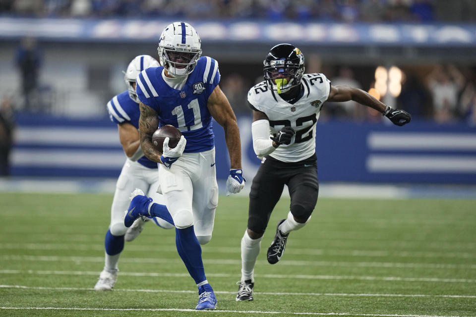 Indianapolis Colts wide receiver Michael Pittman Jr. (11) runs with the ball after catching a 39-yard pass for a touchdown as Jacksonville Jaguars cornerback Tyson Campbell (32) defends during the second half of an NFL football game Sunday, Sept. 10, 2023, in Indianapolis. (AP Photo/Darron Cummings)