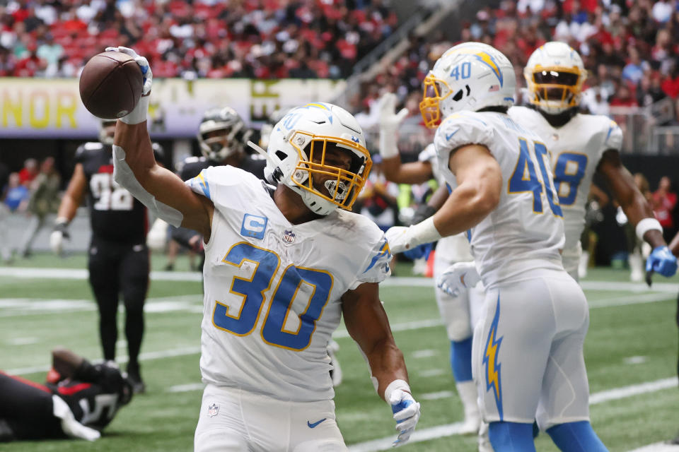 CORRECTS DATE TO SUNDAY, NOV. 6 INSTEAD OF TUESDAY, DEC. 6 - Los Angeles Chargers running back Austin Ekeler (30) celebrates after scoring on a 2-yard touchdown run during the first half of an NFL football game against the Atlanta Falcons, Sunday, Nov. 6, 2022, in Atlanta. (AP Photo/Butch Dill)