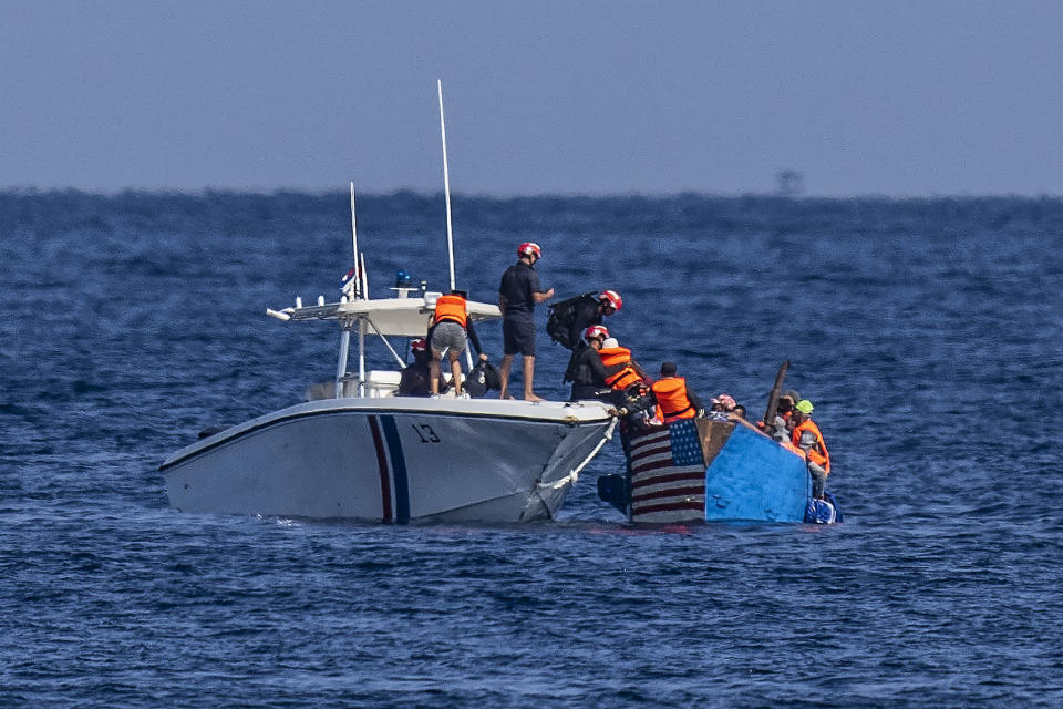 People in a makeshift boat with the U.S. flag painted on the side are captured by the Cuban Coast Guard near the Malecon seawall in Havana, Cuba, on Dec. 12, 2022. (Ramon Espinosa / AP)