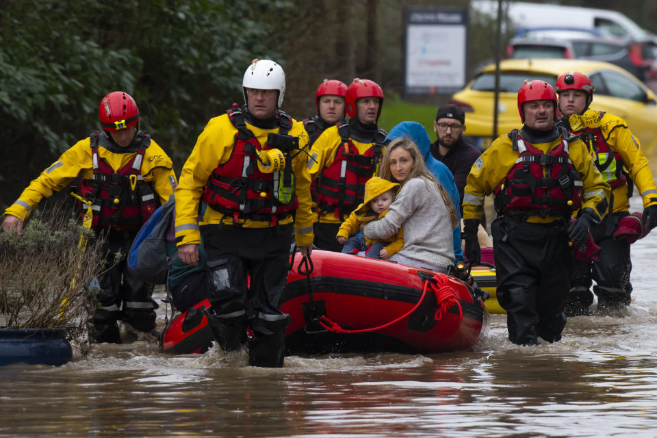 NANTGARW, UNITED KINGDOM - FEBRUARY 16: A family is rescued from a property on Oxford Street on February 16, 2020 in Nantgarw, Wales. The Met Office has issued a red weather warning for rain in Wales and a yellow weather warning for wind for large parts of the UK as storm Dennis passes over the UK. Last week two people were killed as storm Ciara saw parts of the country hit by 93mph winds. (Photo by Matthew Horwood/Getty Images)