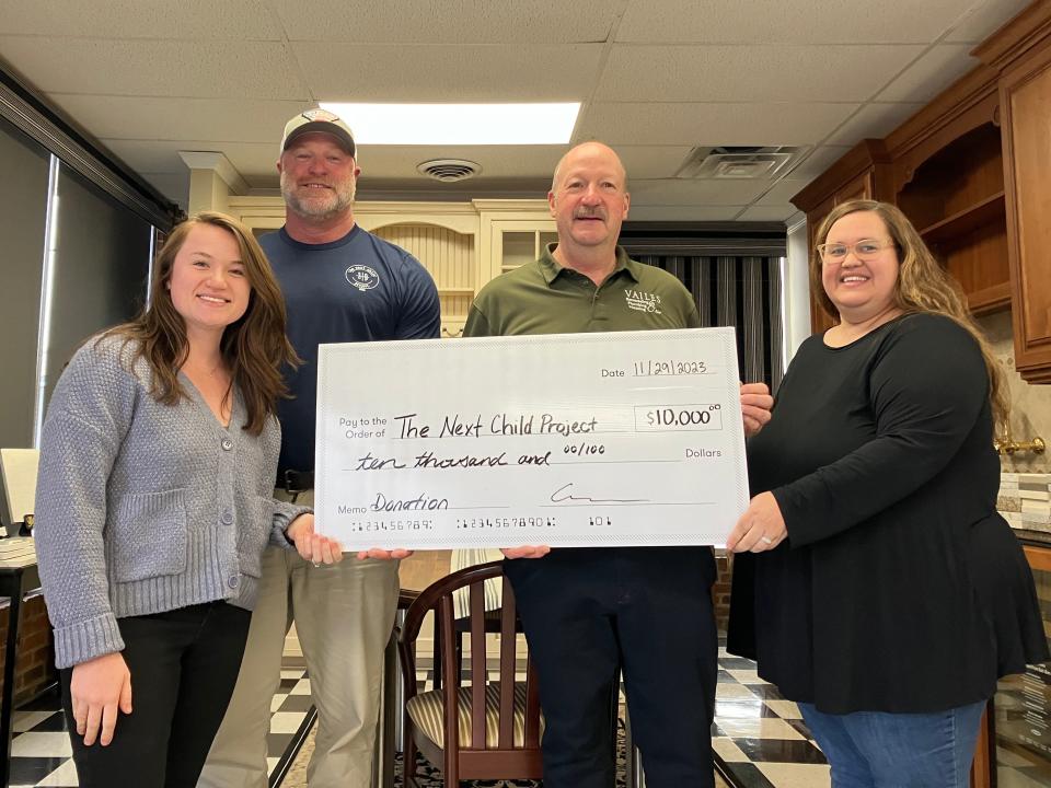 Ben Cash, second from the left, accepts a $10,000 check from Samantha Vailes, Robert Vailes and Julie Simpson Wednesday morning, Nov. 29. Vailes Professional Remodeling, Plumbing, Heating & Air made the donation to Cash's Next Child Project to help families in need during the holiday season.