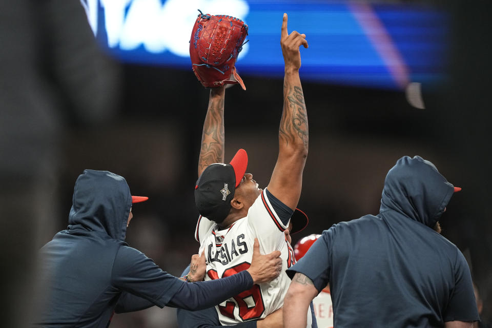 Atlanta Braves relief pitcher Raisel Iglesias (26) celebrates after Game 2 of a baseball NL Division Series against the Philadelphia Phillies, Monday, Oct. 9, 2023, in Atlanta. The Atlanta Braves won 5-4. (AP Photo/Brynn Anderson)