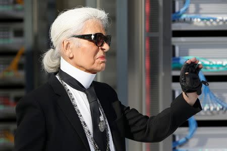 German designer Karl Lagerfeld appears at the end of his Spring/Summer 2017 women's ready-to-wear collection for fashion house Chanel during Fashion Week in Paris, France October 4, 2016.REUTERS/Charles Platiau
