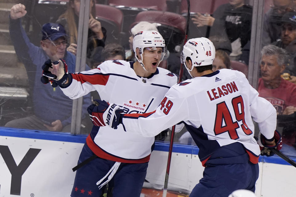 Washington Capitals left wing Beck Malenstyn, left, celebrates his goal with right wing Brett Leason (49) during the first period of an NHL hockey game against the Florida Panthers, Tuesday, Nov. 30, 2021, in Sunrise, Fla. (AP Photo/Wilfredo Lee)