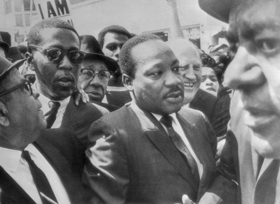 Dr. Martin Luther King (center) is surrounded by leaders of the sanitation strike here as he arrived to lead a march in support of the striking workers on March 28, 1968. Shortly after the march began, bloody violence and looting began, forcing the National Guard to be called in. (Bettmann/Getty Images)