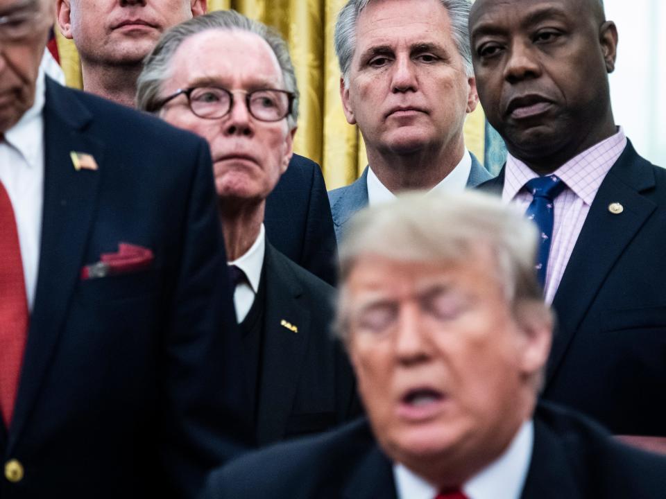 WASHINGTON, DC - DECEMBER 21 : House Majority Leader Kevin McCarthy, R-Calif., and Sen. Tim Scott, R-S.C., listen to President Donald J. Trump during a signing ceremony for S. 756, First Step Act and H.R. 6964, Juvenile Justice Reform Act in the Oval Office at the White House on Friday, Dec. 21, 2018 in Washington, DC. (Photo by Jabin Botsford/The Washington Post via Getty Images)