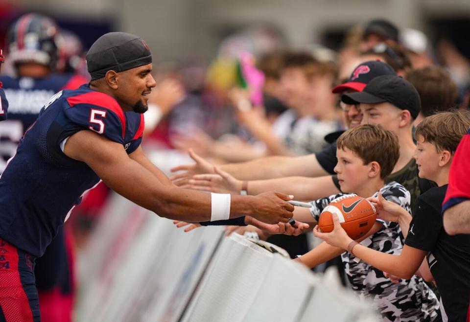 Montreal Alouettes quarterback Caleb Evans (5) signs autographs prior to their CFL football game against the Ottawa Redblacks in Montreal, Thursday, June 20, 2024.  THE CANADIAN PRESS/Christinne Muschi