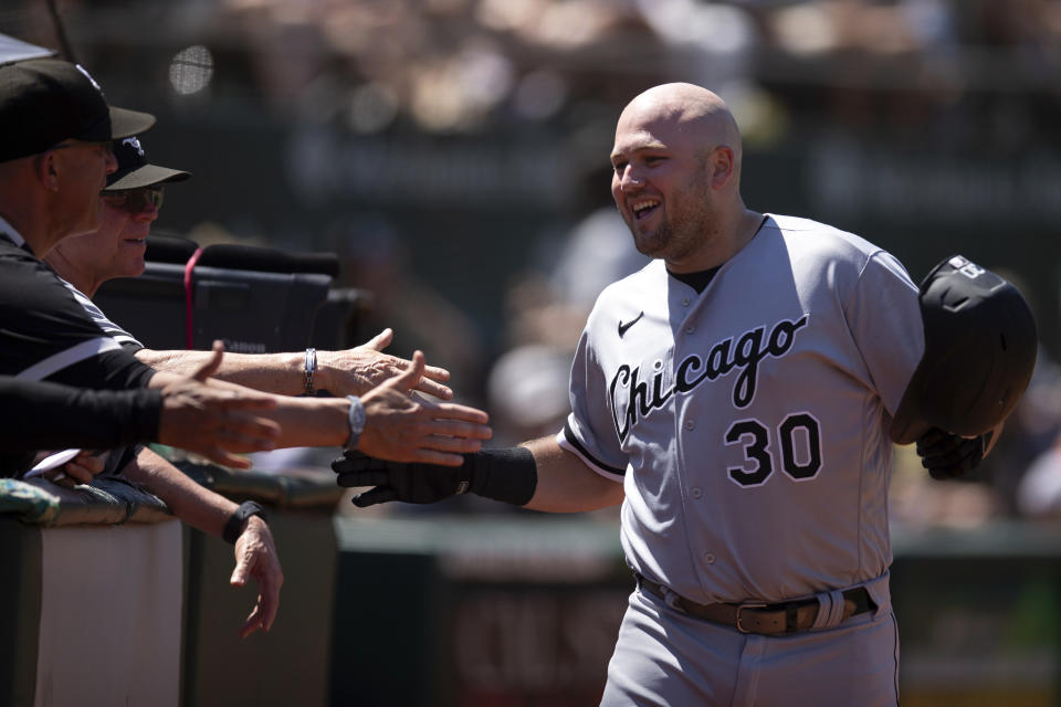 Chicago White Sox's Jake Burger (30) is congratulated by his teammates after hitting a solo home run against the Oakland Athletics during the seventh inning of a baseball game, Sunday, July 2, 2023, in Oakland, Calif. (AP Photo/D. Ross Cameron)