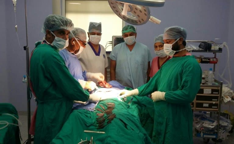 An Indian surgical team operates on a policeman who swallowed over 40 knives, as seen at Amritsar hospital