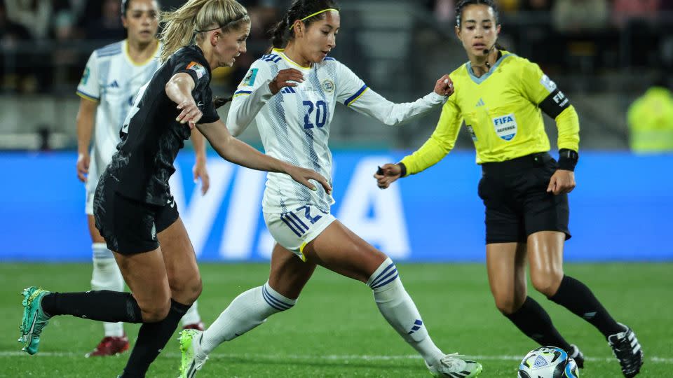 Philippines midfielder Quinley Quezada passes the ball next to New Zealand midfielder Katie Bowen.  - Marty Melville/AFP/Getty Images