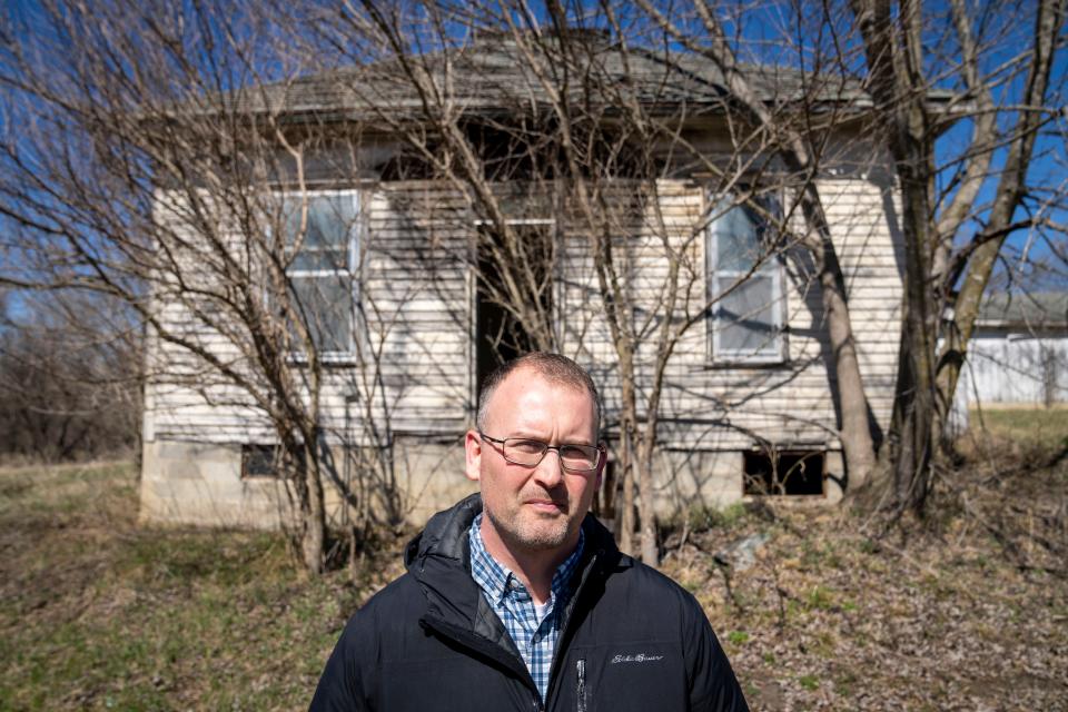 Osceola City Manager Ty Wheeler stands in front of an early 20th century farmstead that an official from Iowa's State Historic Preservation Office says should be considered for placement on the National Register of Historic Places ― possibly endangering plans for a much-needed reservoir there. Local officials disagree.