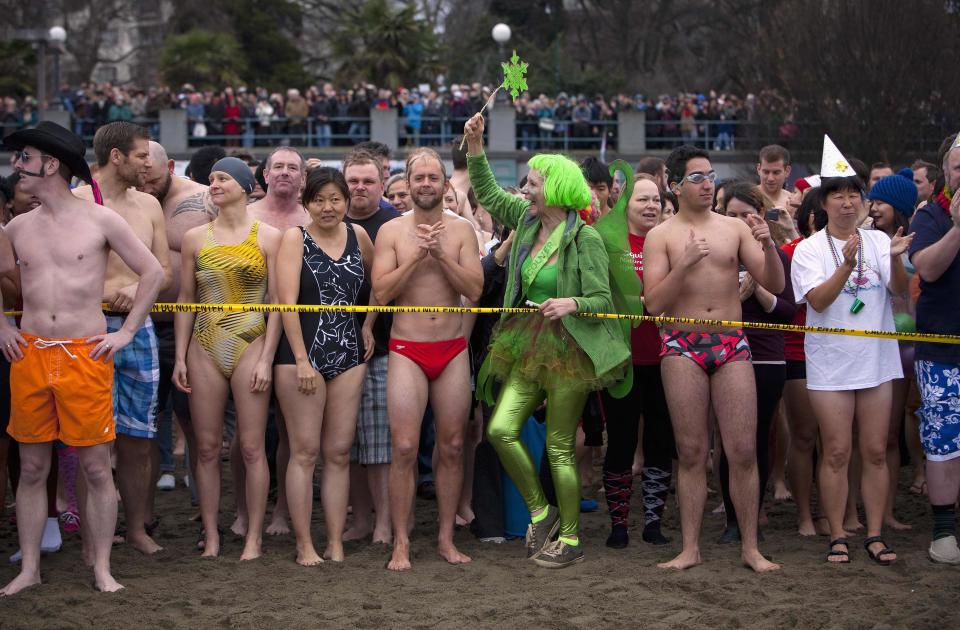 Participants prepare to run into English Bay during the 94th annual New Year's Day Polar Bear Swim in Vancouver