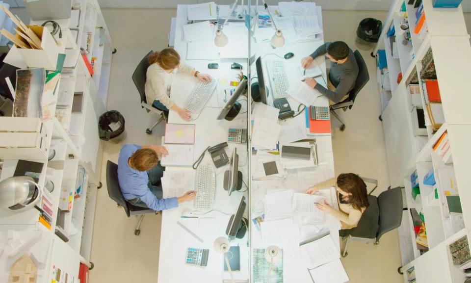 People sitting at desks in office