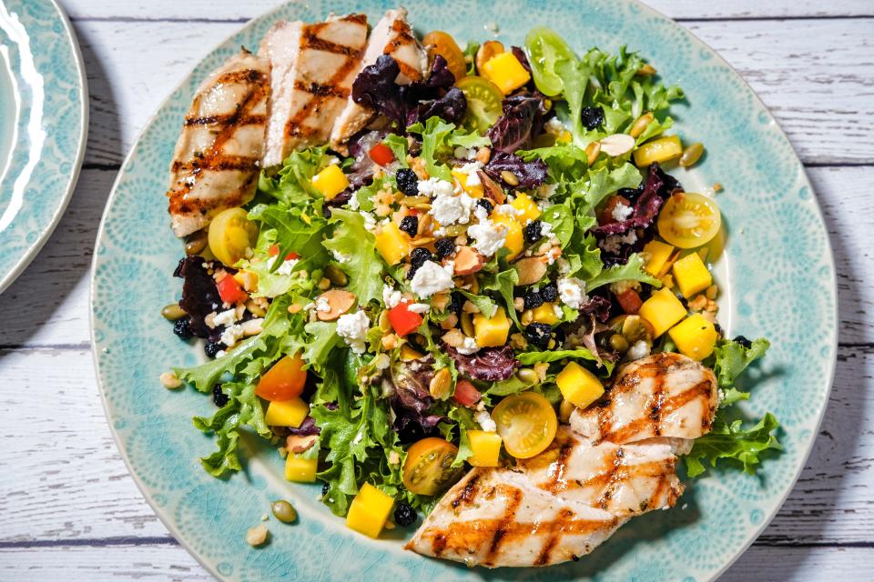 Meals like this chicken and mango salad are available at the Tommy Bahama Marlin Bar, which opened Tuesday, June 20, at The Gardens Mall in Palm Beach Gardens