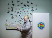 A woman leaves a booth before casting her vote during a presidential election at a polling station in Chisinau, Moldova, October 30, 2016. REUTERS/Gleb Garanich