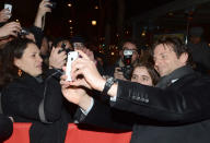 Bradley Cooper made one lucky fan's day when he posed for a pic (he even took it!) while strolling down the red carpet at the Paris premiere of "Silver Linings Playbook." (1/17/2013)