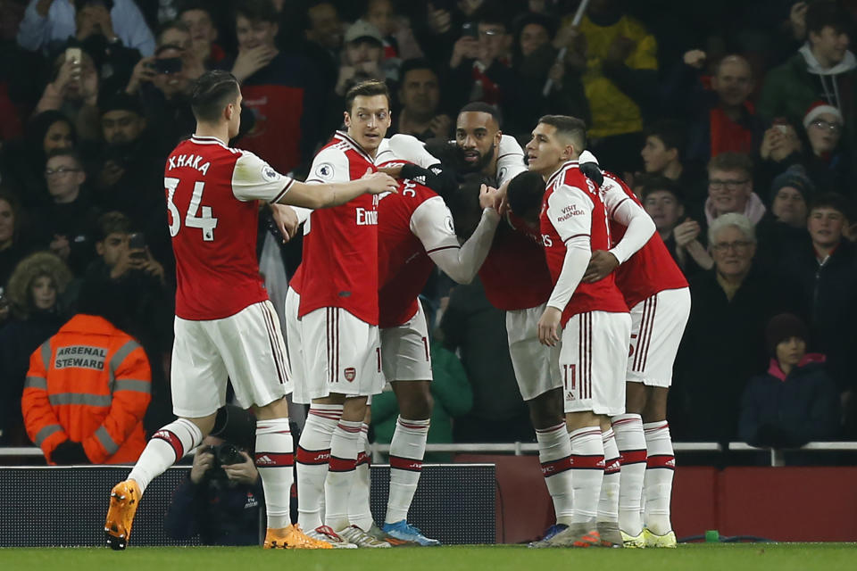 Arsenal's French-born Ivorian midfielder Nicolas Pepe celebrates with teammates after scoring the opening goal of the English Premier League football match between Arsenal and Manchester United at the Emirates Stadium in London on January 1, 2020. (Photo by Ian KINGTON / IKIMAGES / AFP) / RESTRICTED TO EDITORIAL USE. No use with unauthorized audio, video, data, fixture lists, club/league logos or 'live' services. Online in-match use limited to 45 images, no video emulation. No use in betting, games or single club/league/player publications. (Photo by IAN KINGTON/IKIMAGES/AFP via Getty Images)
