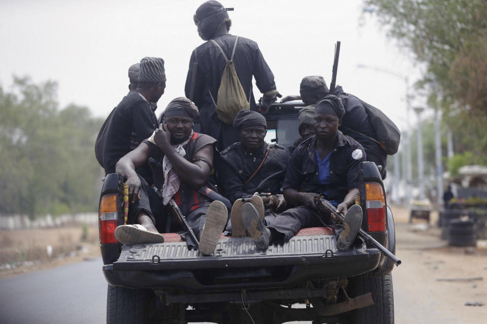 Vigilantes and local hunters armed with locally made guns patrol on the street near the Independent National Electoral Commission office in Yola, Nigeria, Monday Feb. 25, 2019. Official results of Nigeria's presidential election are expected as early Monday in what is being seen as a close race between Incumbent President Muhammadu Buhari and opposition candidate Atiku Abubakar (AP Photo/Sunday Alamba)