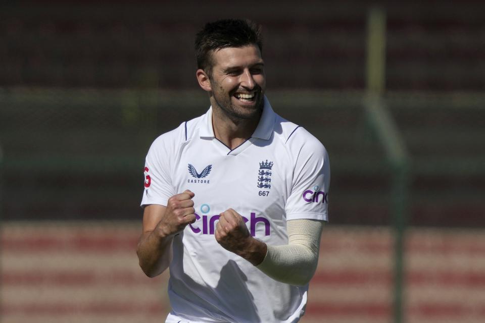England's Mark Wood celebrates after taking the wicket of Pakistan's Shan Masood during the first day of third test cricket match between England and Pakistan, in Karachi, Pakistan, Saturday, Dec. 17, 2022. (AP Photo/Fareed Khan)
