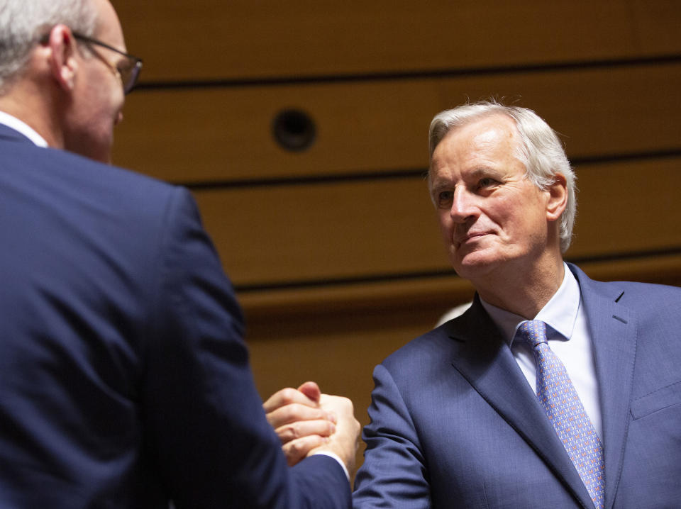 European Union chief Brexit negotiator Michel Barnier, right, shakes hands with Irish Foreign Minister Simon Coveney during a meeting of EU General Affairs ministers, Article 50, at the European Convention Center in Luxembourg, Tuesday, Oct. 15, 2019. European Union chief Brexit negotiator Michel Barnier is in Luxembourg on Tuesday to brief ministers on the state of play for Brexit. (AP Photo/Virginia Mayo)