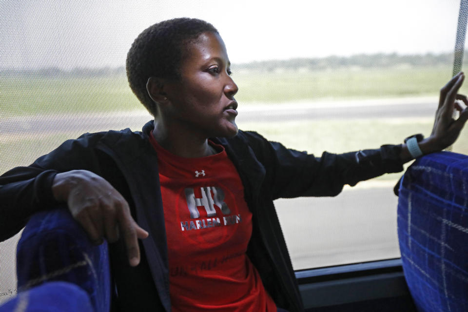 In this Aug. 24, 2018 photo, Alison Desir, with Harlem Run, Run 4 All Women, a collective of runners passionate about running, health, social welfare, women's rights and community involvement, listens as speakers describe their grassroots political programs aboard a Black Voters Matter Fund bus tour in the Mississippi Delta, near Greenville. The tour was in part to introduce traveling national media to a number of hands-on organizations, mainly led by women, that are working throughout the Delta to build interest and excitement for the upcoming election, documenting the campaigning in locales with important upcoming races where black turnout might be key. (AP Photo/Rogelio V. Solis)